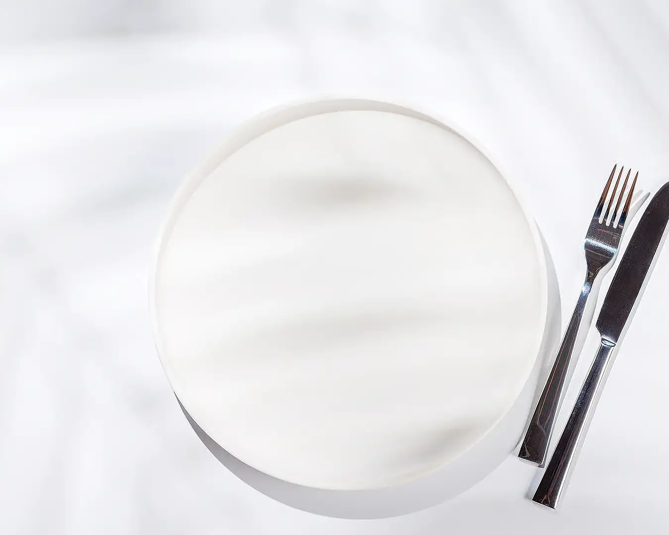 Chef plating an elegant dish, representing restaurant food presentation and menu branding
