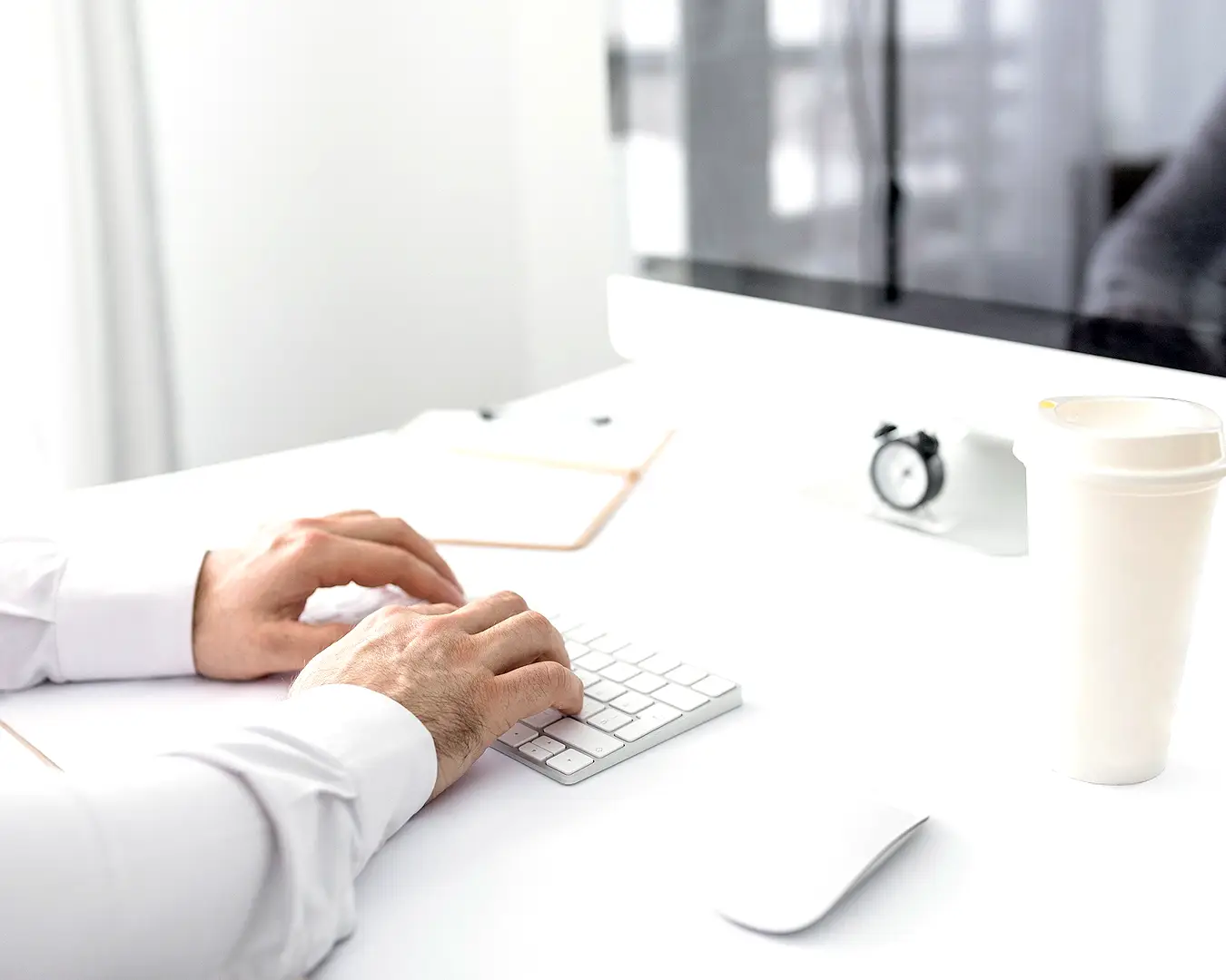 Professional working at a computer in a bright office, representing restaurant brand strategy, planning, and creative development