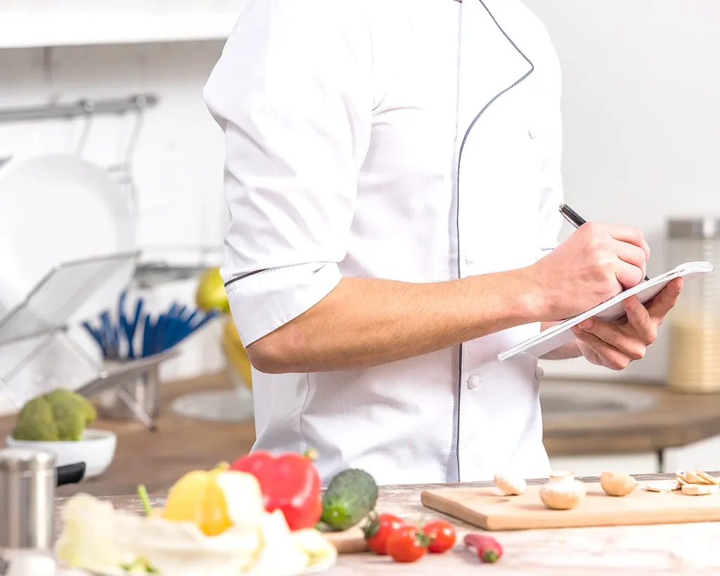 Restaurant server presenting a refined plated dessert, highlighting dining experience and menu design