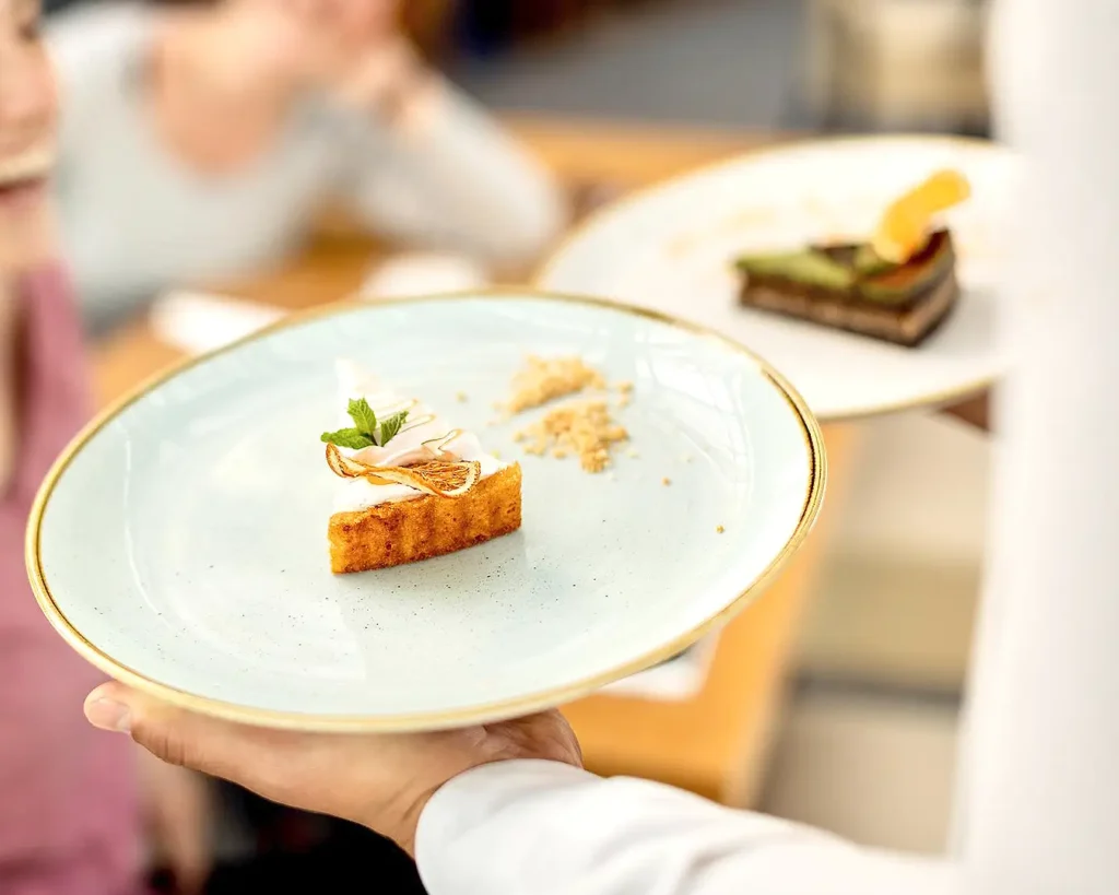 Chef reviewing recipes and food preparation in a professional restaurant kitchen
