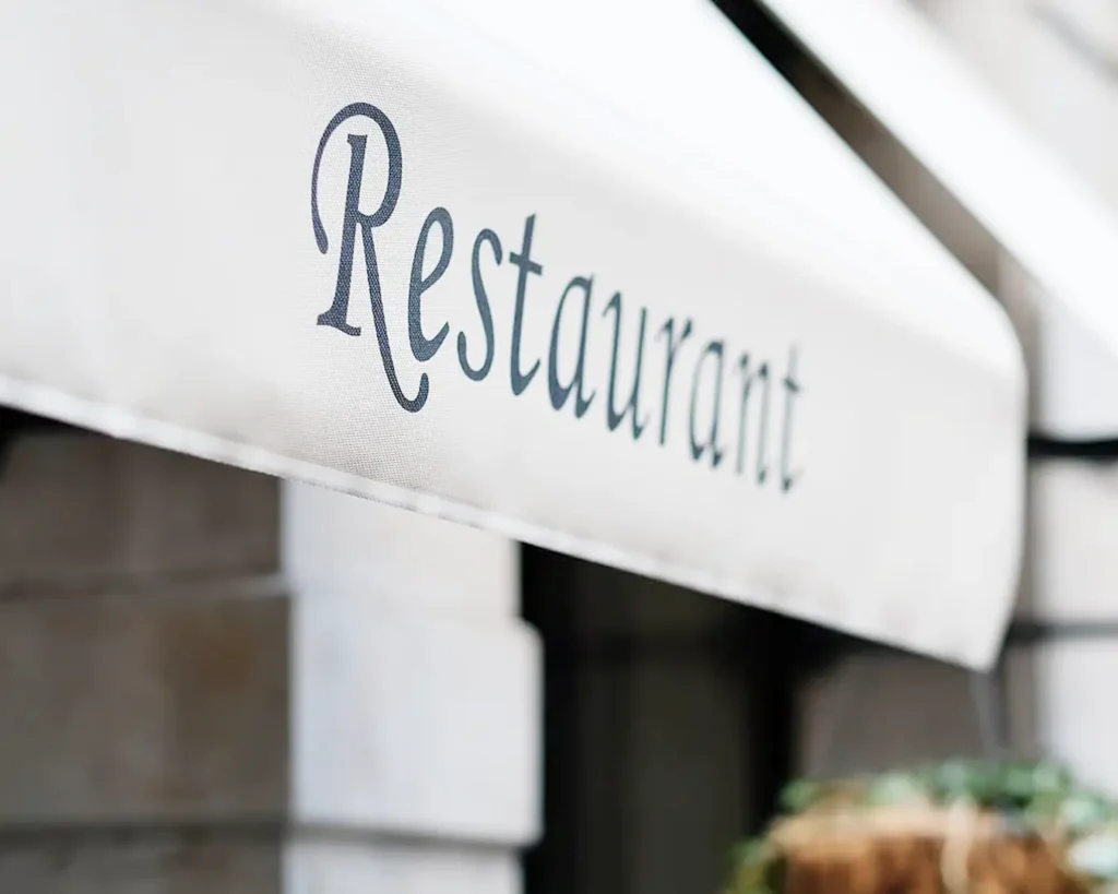 Restaurant exterior signage featuring elegant typography and cohesive hospitality brand identity