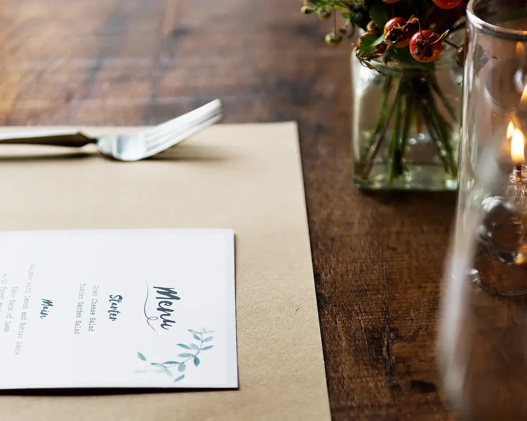 Elegant restaurant menu with script typography, botanical details, and upscale dining presentation
